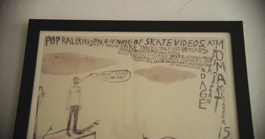 Grayscale poster in a black frame hanging from a wall