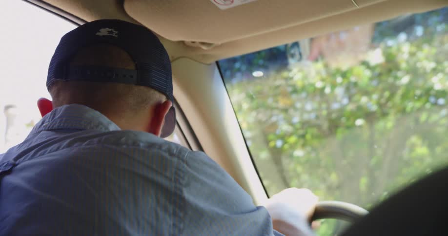 A man driving in a vehicle