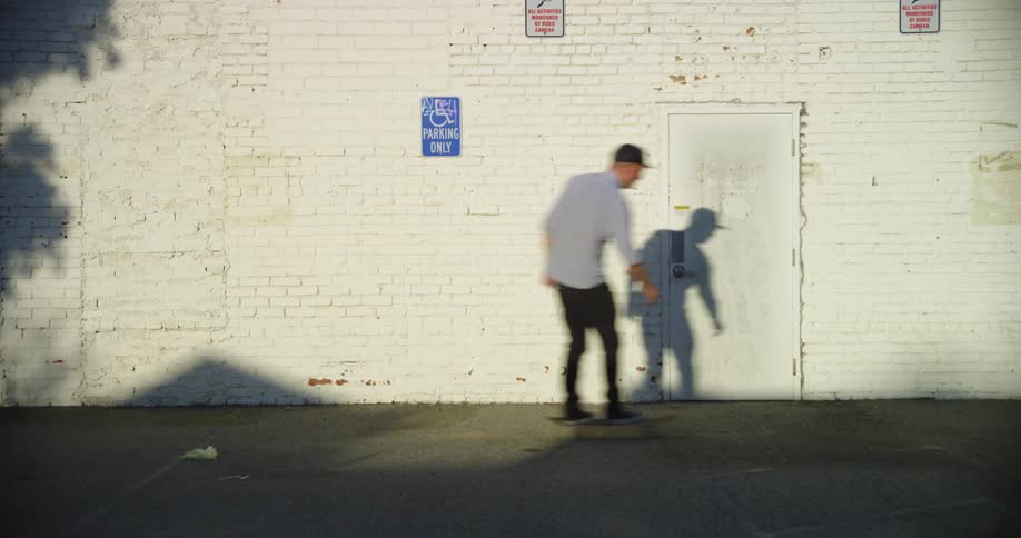 A man skateboarding down a street