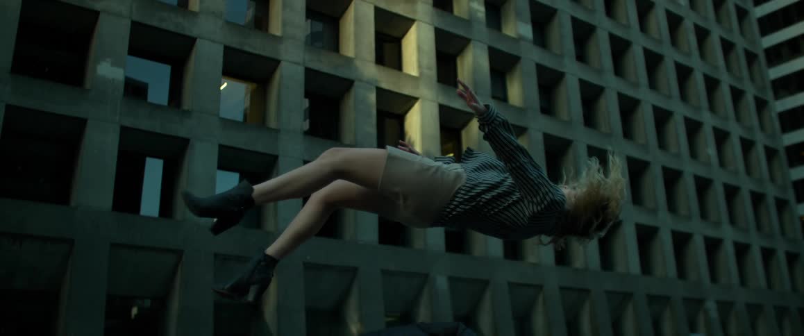 A woman is falling on her back in slow motion