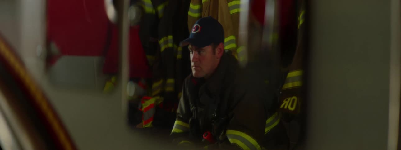 A fire fighter is sitting inside the station