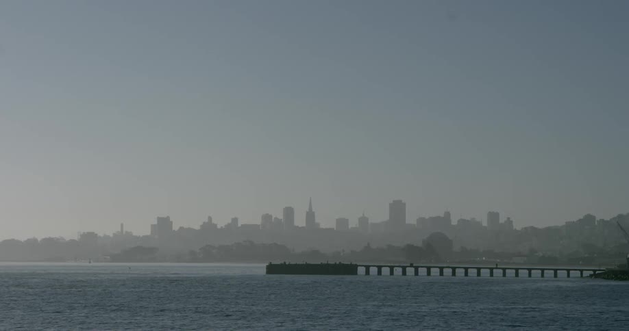 View of a city and a pier at dawn