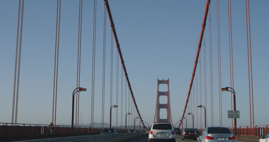 Vehicles are traveling over a large bridge