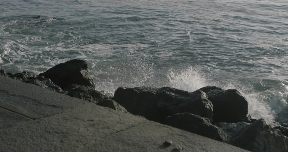 Ocean waves crash into rocks