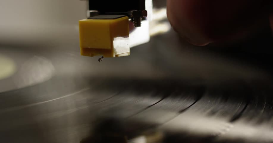 Close up of a record as a needle falls