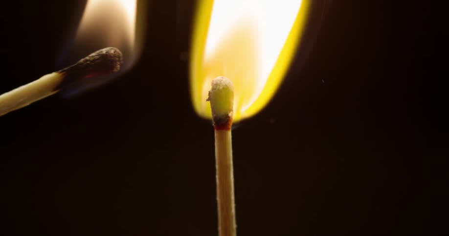 A lit match lights an unlit match