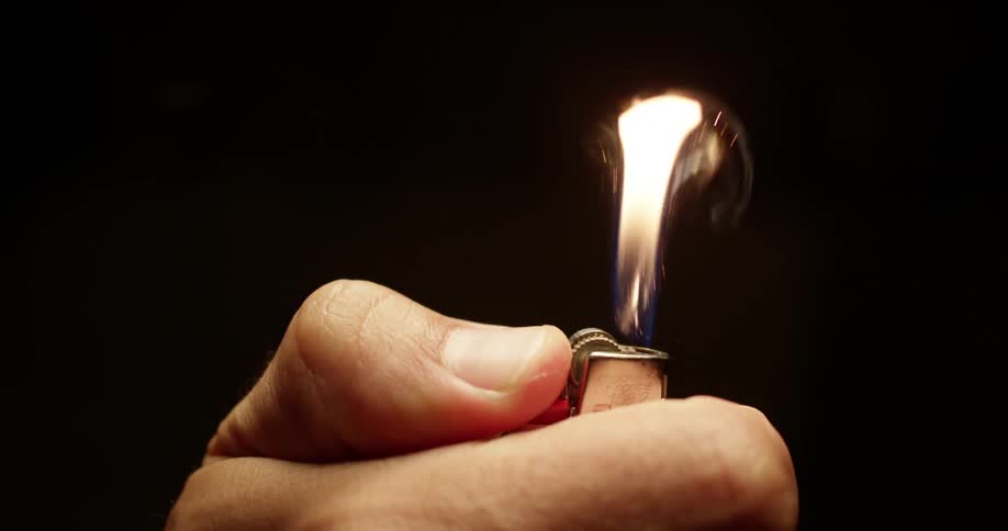 Someone lighting a lighter
