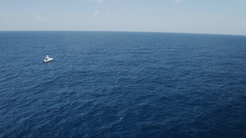 A boat is driving on the ocean
