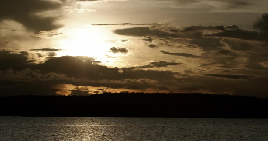 The sun setting over the ocean