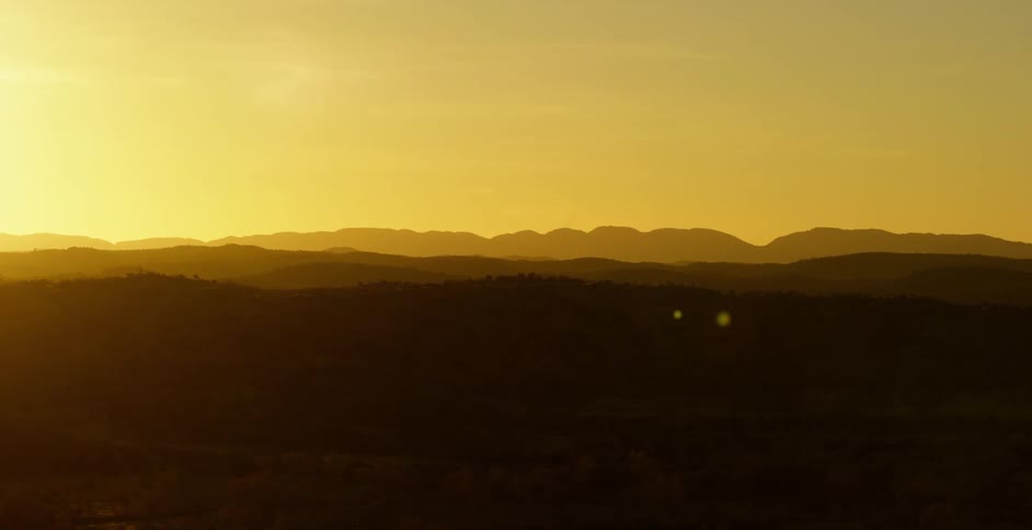 A view of the landscape is displayed while the sun is setting