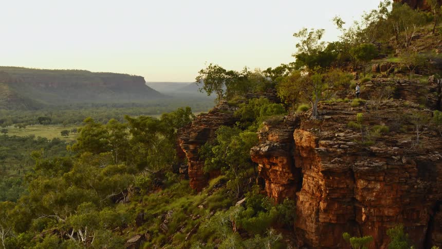 A man stands by the edge of the cliff