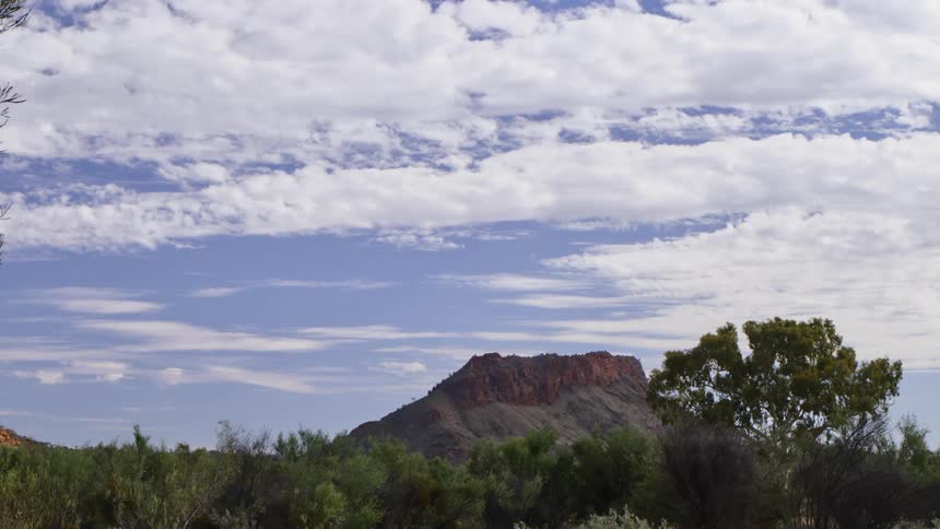 Clouds float above a rock formation in nature