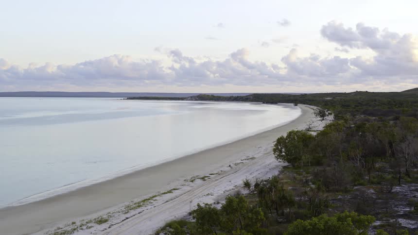 An aerial view of a beach and the water