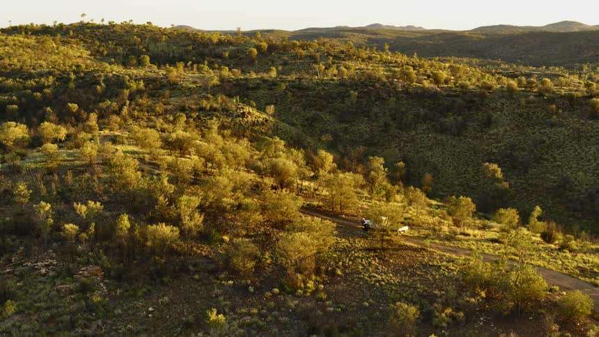 A truck is driving through the countryside