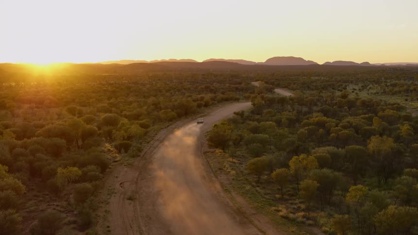 Truck driving across a dirt road in the countryside