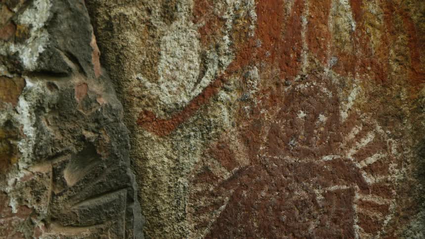 Ancient archaeological pictograph on the vertical stone wall