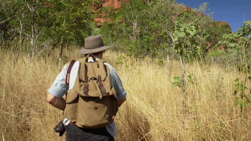 A man is hiking in the wilderness