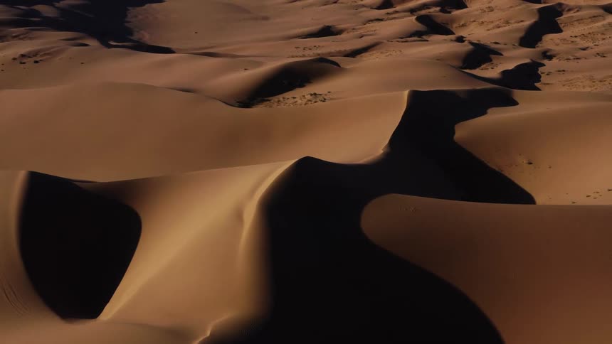 An aerial view of a desert is displayed