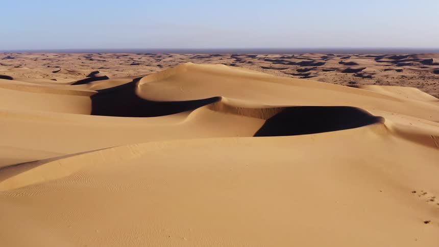 An aerial view of a desert is displayed