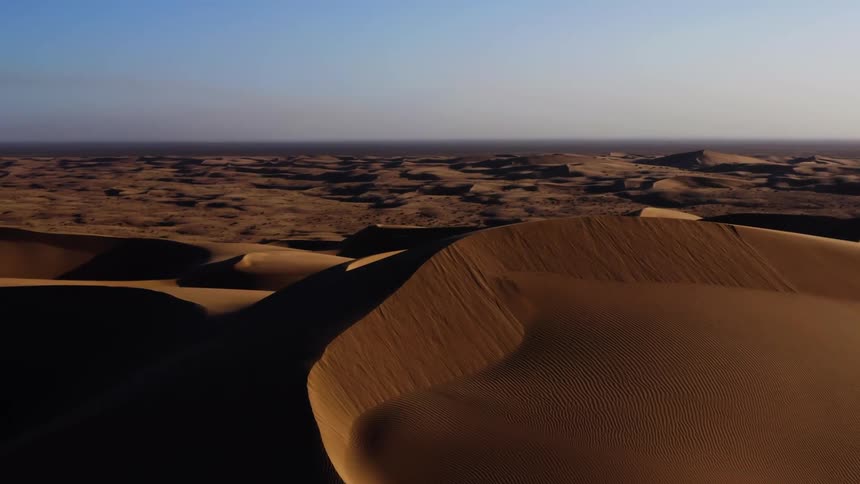 An aerial view of a desert is displayed