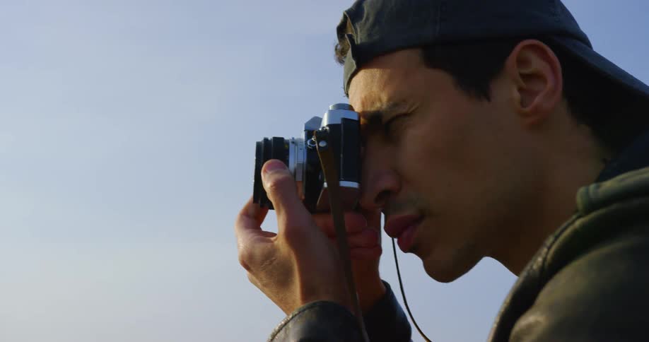 A man is using a camera to take photographs