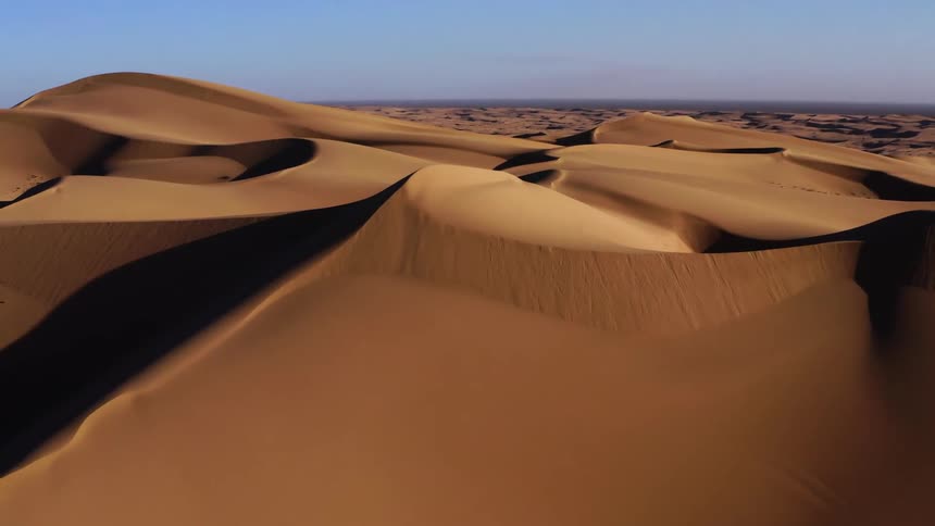 An aerial view of desert sand dunes
