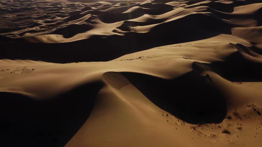An aerial view of sand dunes in a remote desert