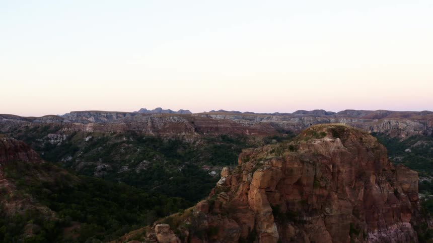 An aerial view of cliffs and canyons and the valley