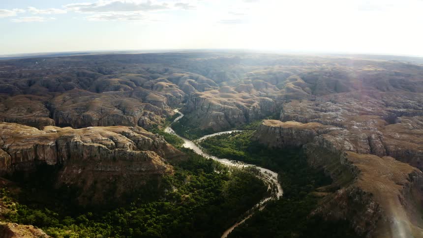 A dried river through a large canyon on a sunny day