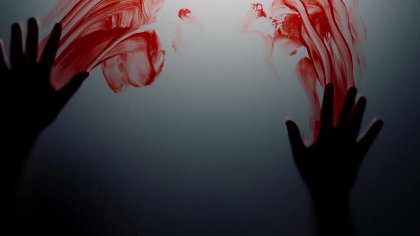 Silhouette of hands hitting a surface and leaving a trail of fresh red blood in a dimly lit room