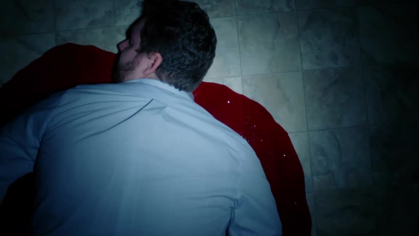 A man lying in a pool of blood