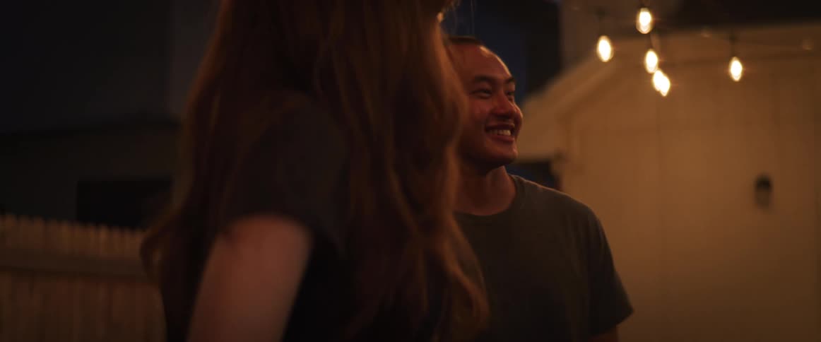 Friends talking and laughing in a back yard