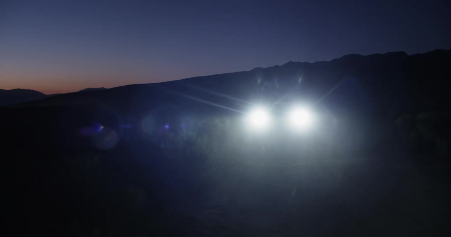 A vehicle in the desert at night