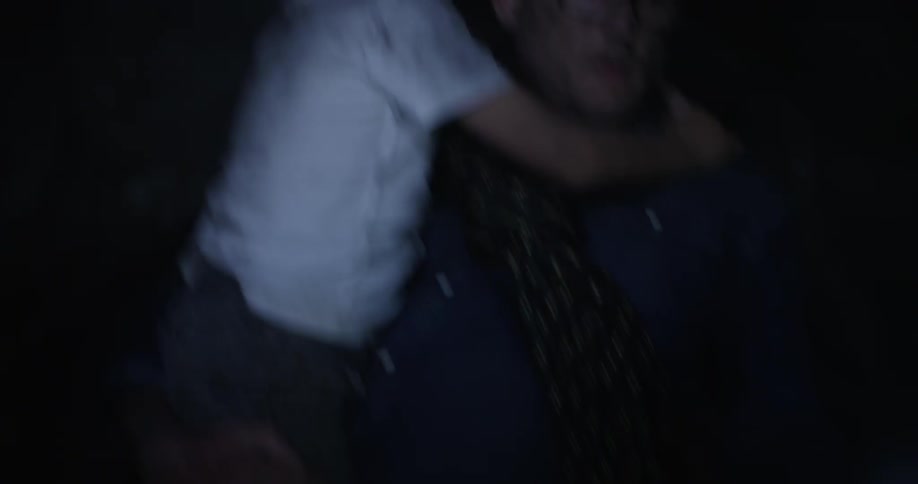 A man carrying a boy through a cave