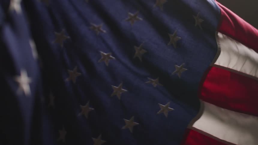 The united states flag blowing in the wind