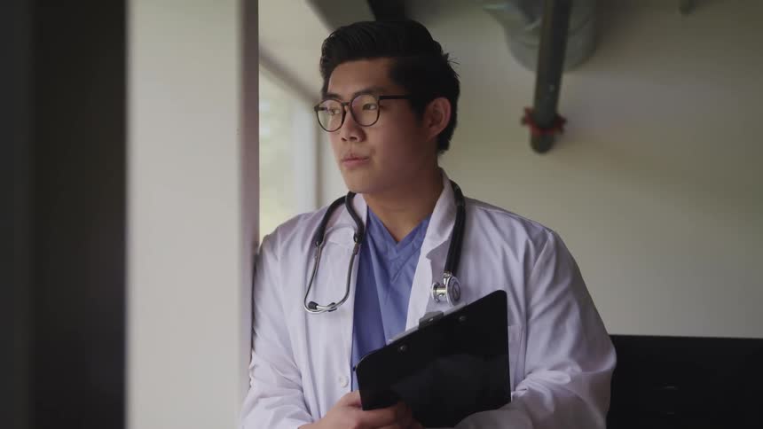 A doctor staring out a window