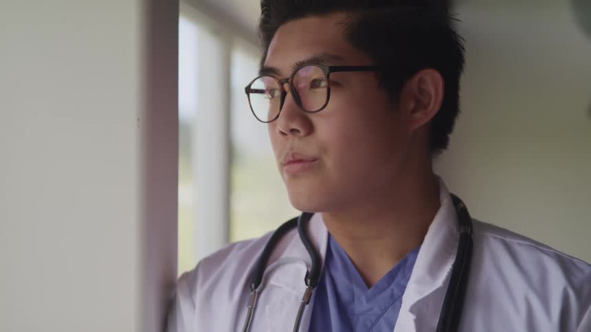 A doctor looking out a window