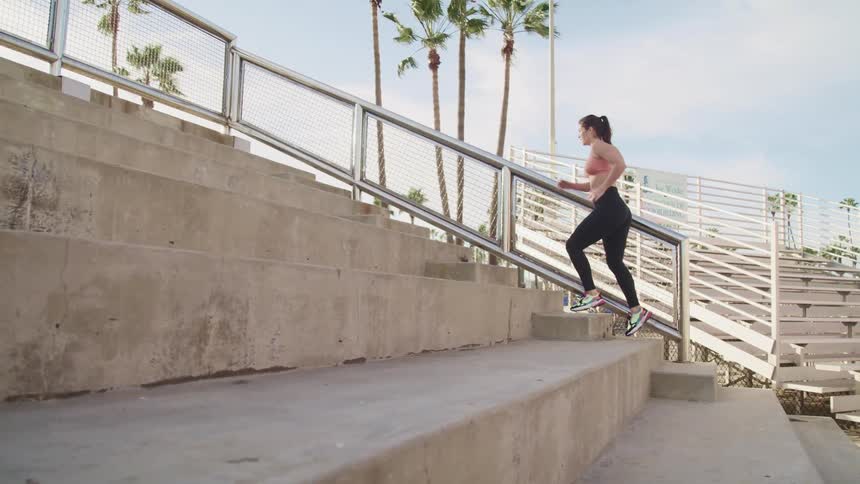 A woman is racing up the steps