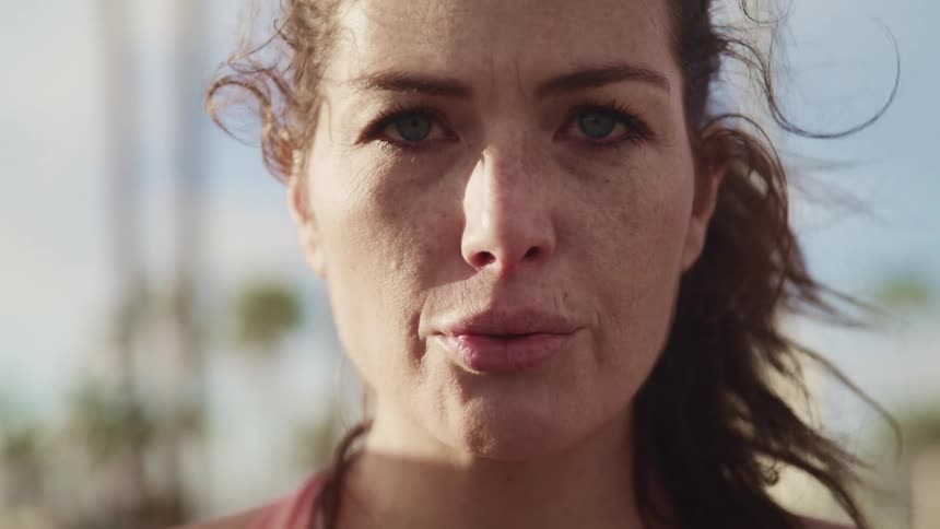 A woman breathing deeply outside