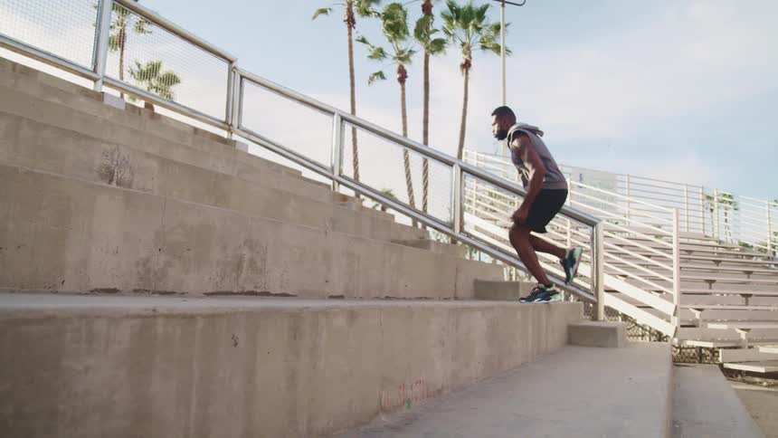 A man is running up the stone steps