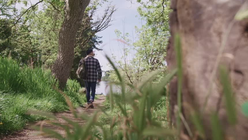 A man is hiking up the trail
