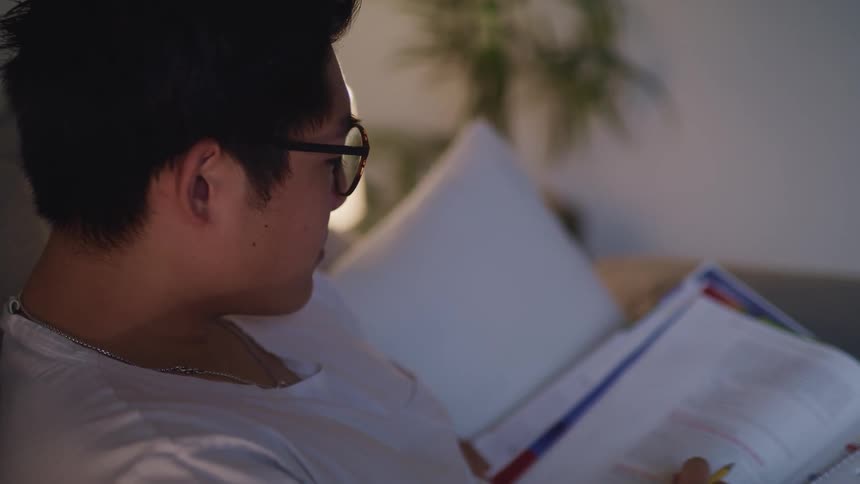 A man sitting at home reading