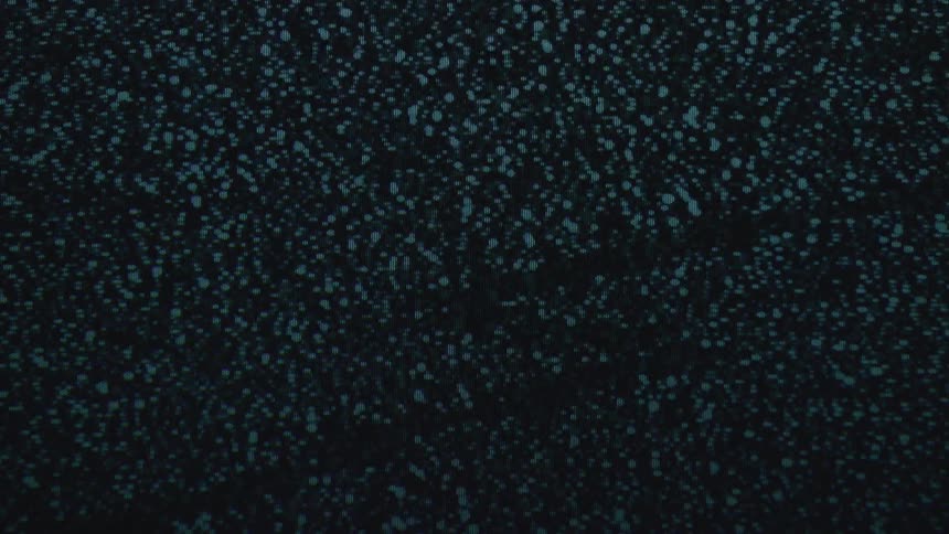 A screen displays flickering and distorted static against a black background