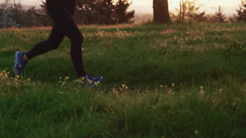 A woman running across a grassy field