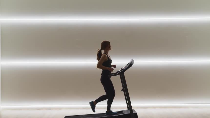 A woman running on a treadmill