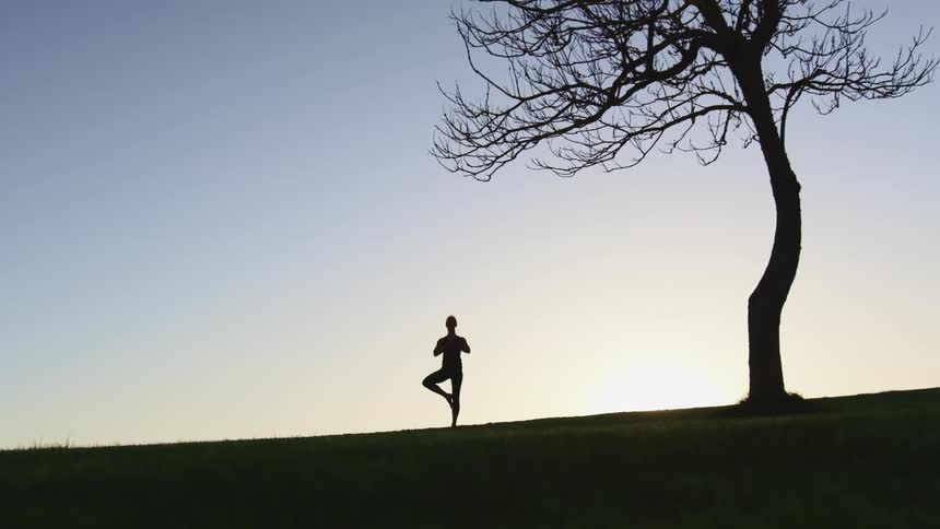 A woman doing yoga outside