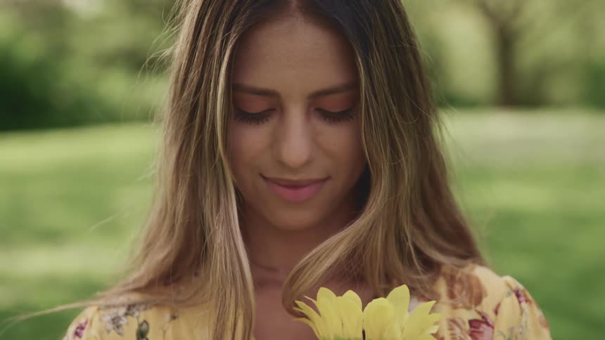 A teenage girl holds a bouquet of flowers