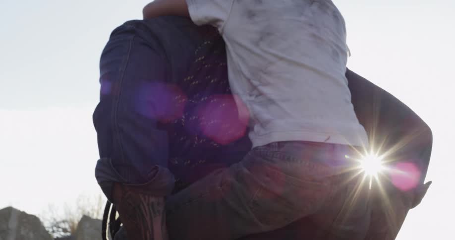 A child holds onto a man's back