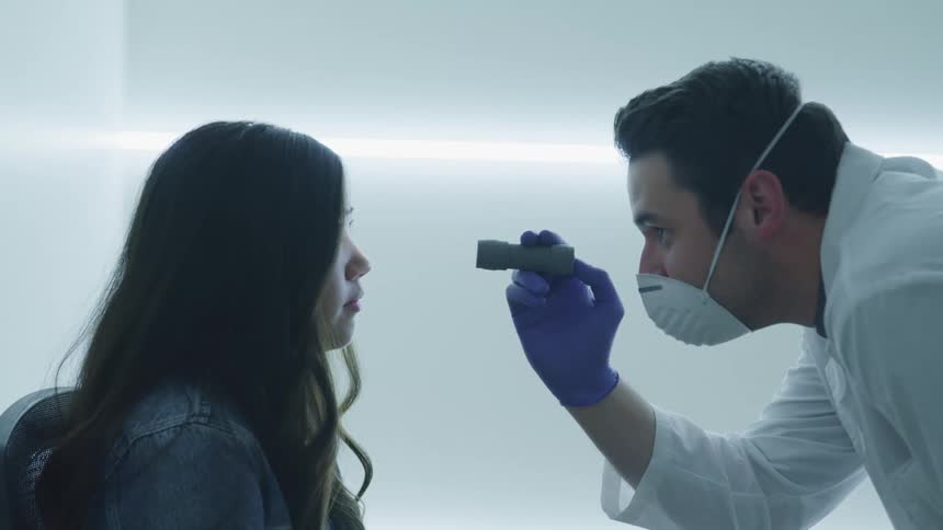 A doctor examines a patients eyes