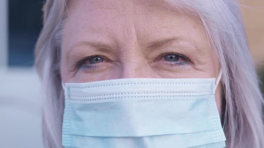 An elderly woman with a mask on